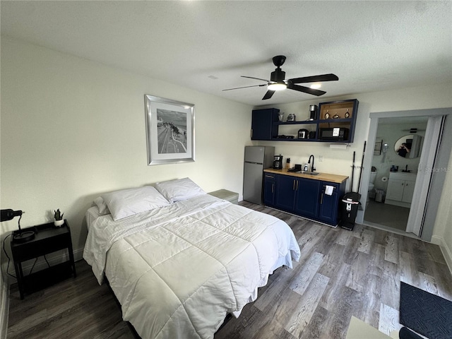 2509 Thornbrook Pl, Tampa, FL 33618 - bedroom with freestanding refrigerator, wood finished floors, ceiling fan, and a textured ceiling
