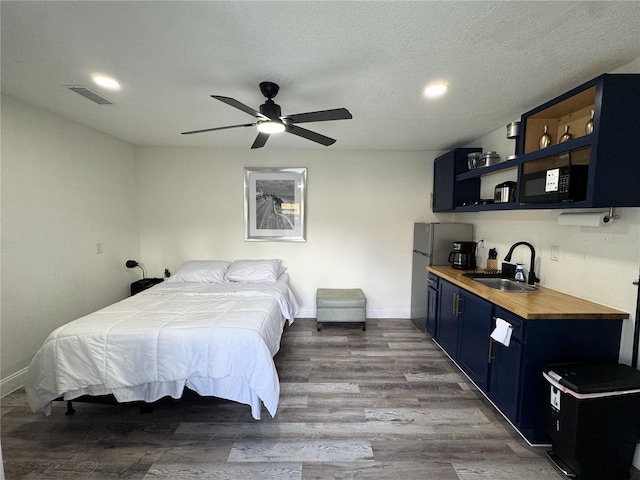 2509 Thornbrook Pl, Tampa, FL 33618 - bedroom featuring wood finished floors, recessed lighting, and freestanding refrigerator