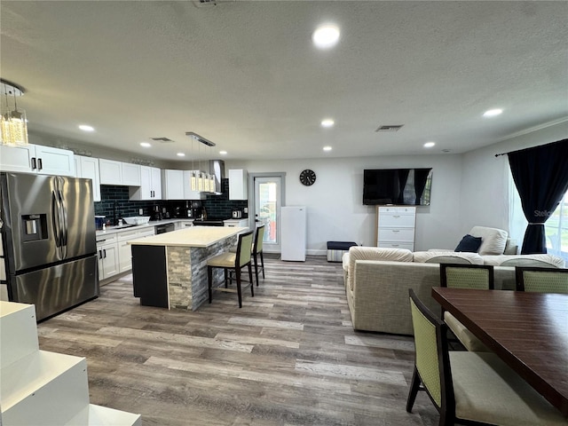 2509 Thornbrook Pl, Tampa, FL 33618 - living room with wood finished floors, recessed lighting, and a textured ceiling