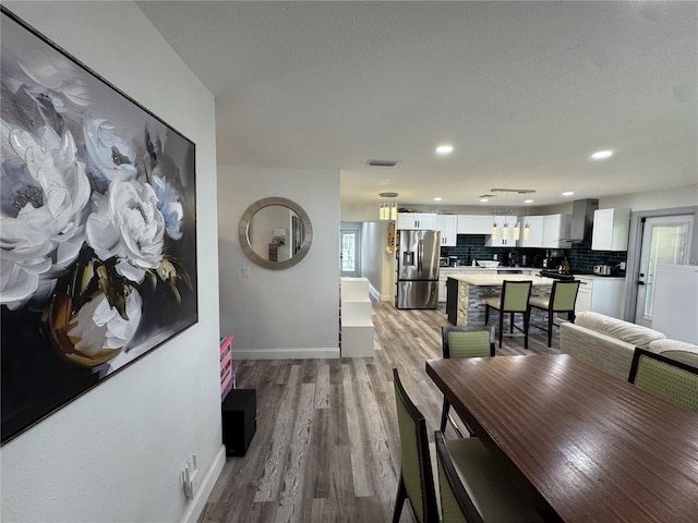 2509 Thornbrook Pl, Tampa, FL 33618 - dining room with light wood finished floors, recessed lighting, and a textured ceiling