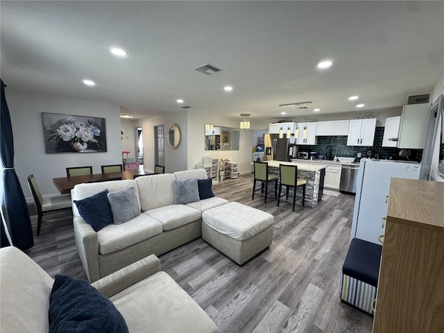 2509 Thornbrook Pl, Tampa, FL 33618 - living room featuring wood finished floors and recessed lighting