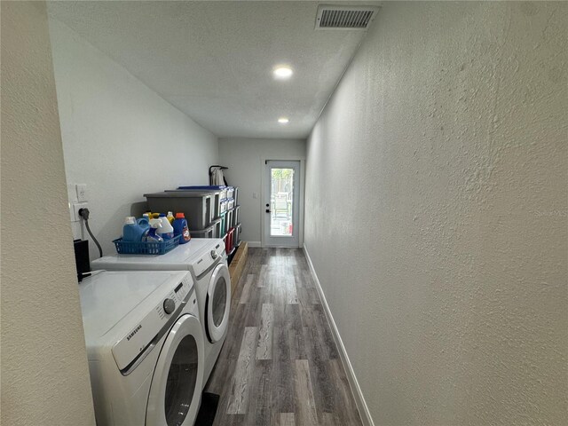 2509 Thornbrook Pl, Tampa, FL 33618 - laundry area featuring washer and clothes dryer, a textured wall, dark wood-style floors, a textured ceiling, and recessed lighting