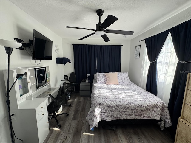 2509 Thornbrook Pl, Tampa, FL 33618 - bedroom featuring a textured ceiling, dark wood-style flooring, an office area, and a ceiling fan