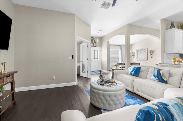 12333 Harris Hawk Rd, Weeki Wachee, FL 34614 - living area with dark wood-style floors and arched walkways