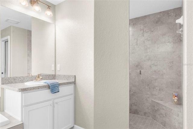 12333 Harris Hawk Rd, Weeki Wachee, FL 34614 - full bath featuring vanity, tiled shower, and a textured wall