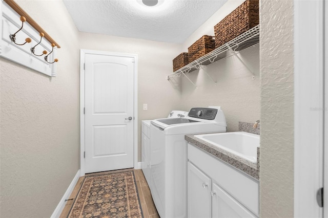 12333 Harris Hawk Rd, Weeki Wachee, FL 34614 - laundry area featuring separate washer and dryer and a textured ceiling