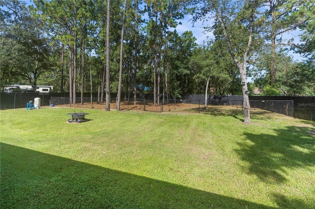12333 Harris Hawk Rd, Weeki Wachee, FL 34614 - fenced backyard with a fire pit