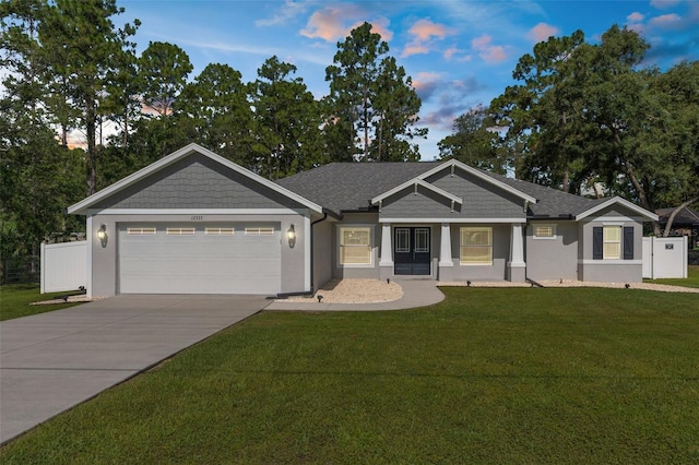 12333 Harris Hawk Rd, Weeki Wachee, FL 34614 - view of front of property featuring an attached garage, concrete driveway, and stucco siding