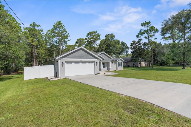12333 Harris Hawk Rd, Weeki Wachee, FL 34614 - ranch-style house with driveway, an attached garage, stucco siding, and view of scattered trees