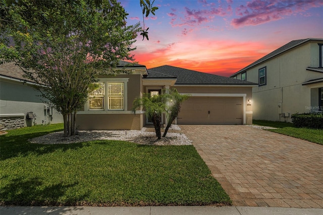 12322 Eagle Swoop Pl, Riverview, FL 33579 - view of front of property with stucco siding, decorative driveway, a garage, and a front yard