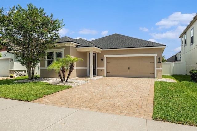 12322 Eagle Swoop Pl, Riverview, FL 33579 - view of front of home featuring stucco siding, a garage, decorative driveway, and roof with shingles