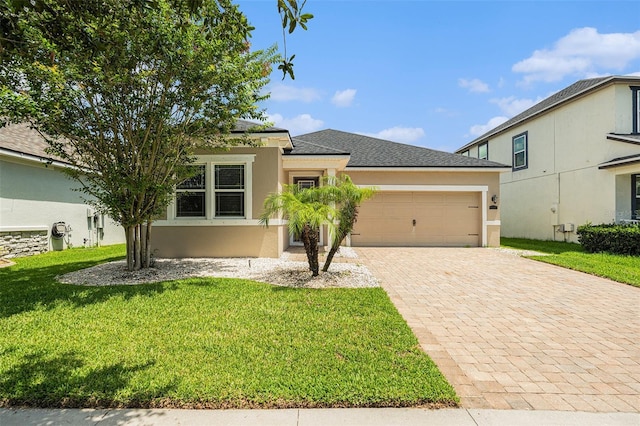 12322 Eagle Swoop Pl, Riverview, FL 33579 - view of front of property with decorative driveway, stucco siding, an attached garage, a front lawn, and a shingled roof