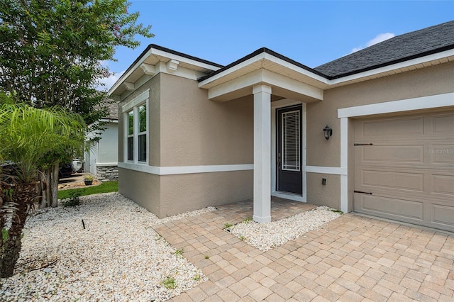 12322 Eagle Swoop Pl, Riverview, FL 33579 - doorway to property with stucco siding and an attached garage