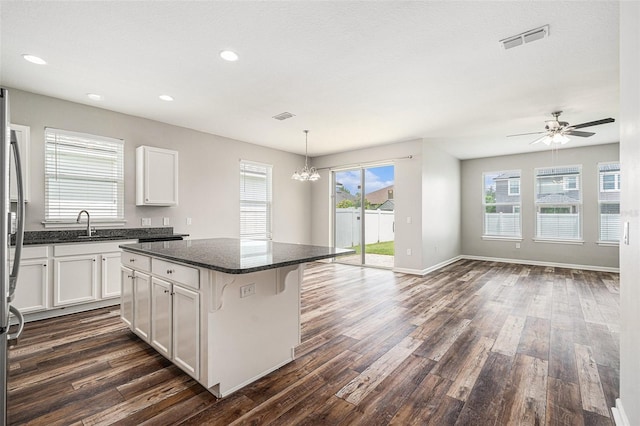12322 Eagle Swoop Pl, Riverview, FL 33579 - kitchen featuring dark wood-type flooring, a kitchen island, white cabinetry, a chandelier, and recessed lighting
