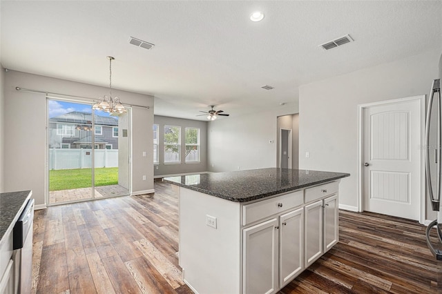 12322 Eagle Swoop Pl, Riverview, FL 33579 - kitchen featuring dark wood finished floors, dark stone counters, ceiling fan, a chandelier, and recessed lighting