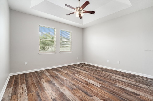 12322 Eagle Swoop Pl, Riverview, FL 33579 - spare room with dark wood-style flooring, a raised ceiling, and ceiling fan