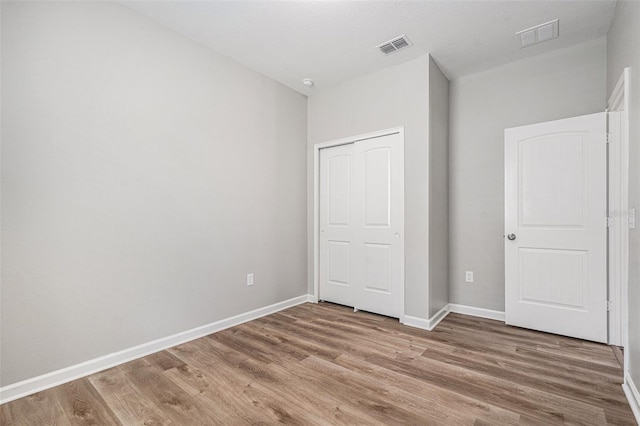 12322 Eagle Swoop Pl, Riverview, FL 33579 - unfurnished bedroom with light wood-style flooring and a closet