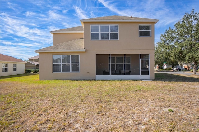 3921 SW 51st Ter, Ocala, FL 34474 - rear view of house with stucco siding, a sunroom, a yard, and roof with shingles