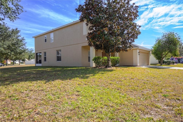 3921 SW 51st Ter, Ocala, FL 34474 - view of side of home featuring stucco siding, a garage, concrete driveway, and a lawn