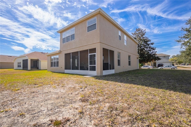 3921 SW 51st Ter, Ocala, FL 34474 - rear view of property with a sunroom, stucco siding, and a lawn