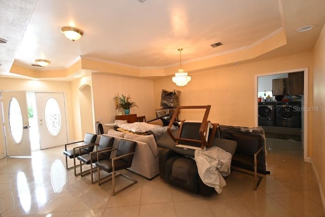 21921 US Highway 98, Dade City, FL 33523 - living room featuring a raised ceiling, independent washer and dryer, light tile patterned floors, and crown molding