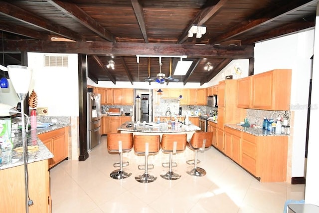 21921 US Highway 98, Dade City, FL 33523 - kitchen featuring appliances with stainless steel finishes, decorative backsplash, a kitchen island, light stone counters, and wooden ceiling