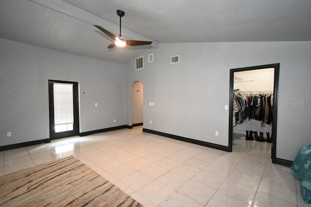 21921 US Highway 98, Dade City, FL 33523 - empty room featuring arched walkways, a ceiling fan, light tile patterned flooring, beam ceiling, and high vaulted ceiling