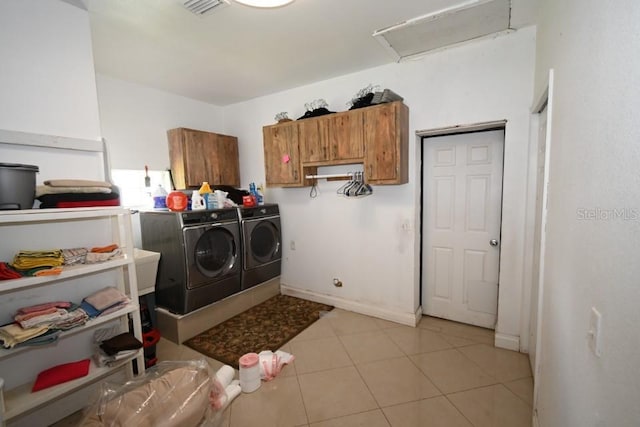21921 US Highway 98, Dade City, FL 33523 - laundry room with washing machine and clothes dryer, cabinet space, attic access, and light tile patterned floors