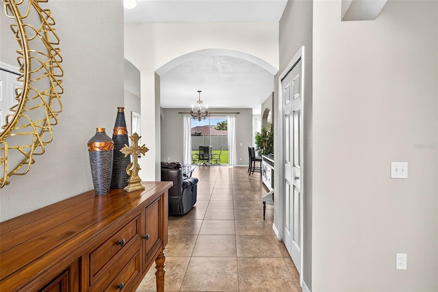 19028 Narimore Dr, Land O Lakes, FL 34638 - hallway with arched walkways and a chandelier