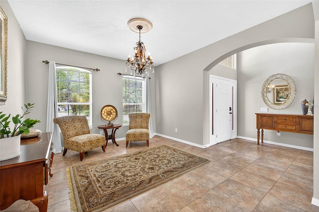 19028 Narimore Dr, Land O Lakes, FL 34638 - living area featuring arched walkways, a chandelier, and light tile patterned flooring