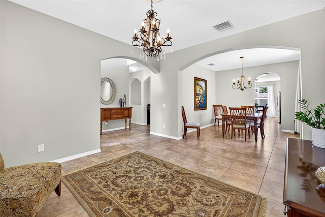 19028 Narimore Dr, Land O Lakes, FL 34638 - dining space featuring a chandelier, arched walkways, and tile patterned flooring