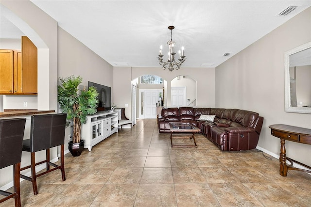 19028 Narimore Dr, Land O Lakes, FL 34638 - living area with arched walkways and a chandelier