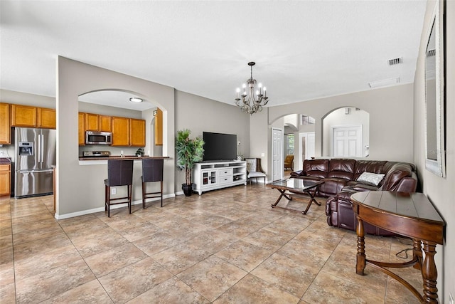 19028 Narimore Dr, Land O Lakes, FL 34638 - living room with arched walkways and a chandelier