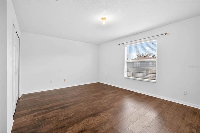 19028 Narimore Dr, Land O Lakes, FL 34638 - unfurnished bedroom with dark wood-style floors and baseboards