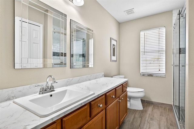 19028 Narimore Dr, Land O Lakes, FL 34638 - full bath featuring vanity, a shower stall, and wood finished floors