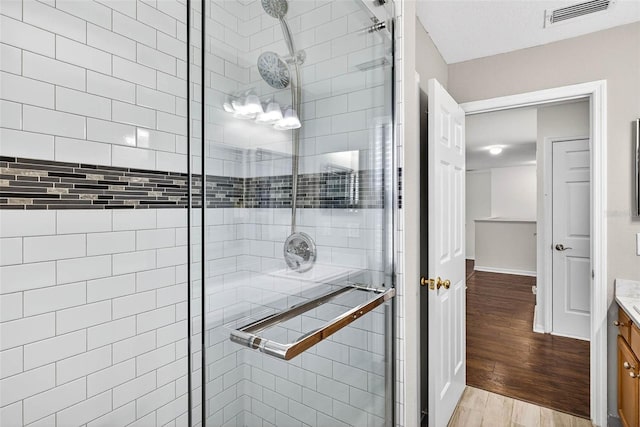 19028 Narimore Dr, Land O Lakes, FL 34638 - full bathroom featuring vanity, a shower stall, and wood finished floors