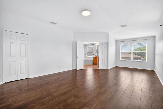 19028 Narimore Dr, Land O Lakes, FL 34638 - unfurnished bedroom featuring dark wood-type flooring and ensuite bath