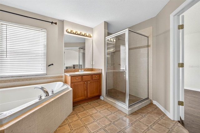19028 Narimore Dr, Land O Lakes, FL 34638 - full bathroom featuring vanity, a garden tub, and a shower stall