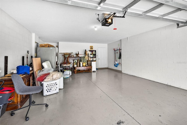 19028 Narimore Dr, Land O Lakes, FL 34638 - garage with a garage door opener, freestanding refrigerator, and concrete block wall