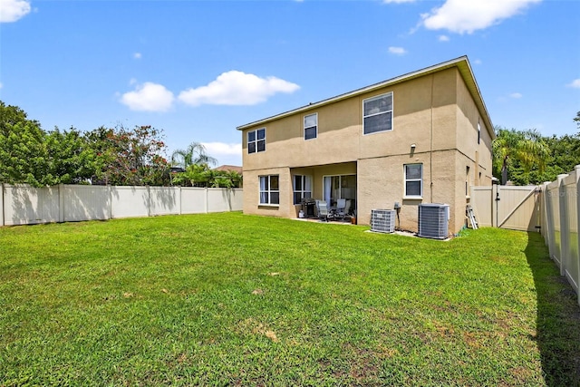 19028 Narimore Dr, Land O Lakes, FL 34638 - back of house with stucco siding, a gate, and a fenced backyard