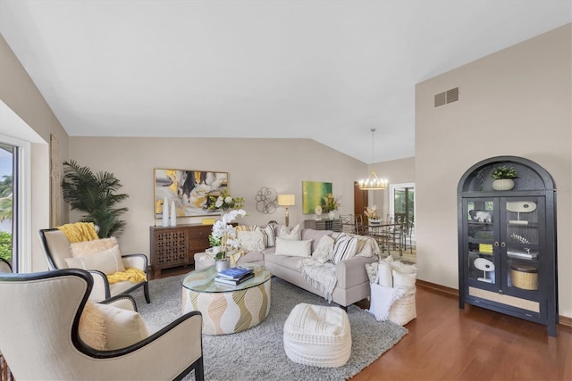 2174 Kent Ave, Clearwater, FL 33764 - living room with a chandelier, wood finished floors, and vaulted ceiling