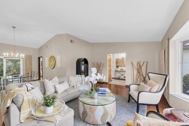 2174 Kent Ave, Clearwater, FL 33764 - living area featuring a chandelier, wood finished floors, and lofted ceiling