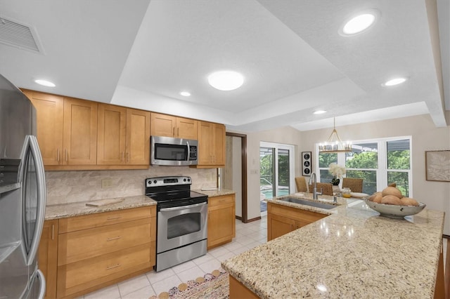 2174 Kent Ave, Clearwater, FL 33764 - kitchen with appliances with stainless steel finishes, plenty of natural light, tasteful backsplash, light tile patterned flooring, and recessed lighting
