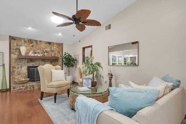 2174 Kent Ave, Clearwater, FL 33764 - living room with vaulted ceiling, wood finished floors, a ceiling fan, and a fireplace