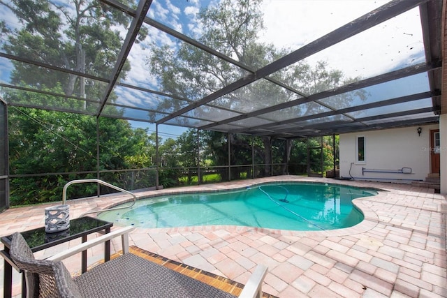 2174 Kent Ave, Clearwater, FL 33764 - outdoor pool featuring a patio, view of wooded area, and a lanai
