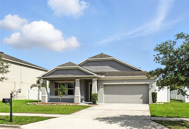 303 Briarbrook Ln, Haines City, FL 33844 - view of front facade featuring driveway, a garage, stucco siding, and covered porch