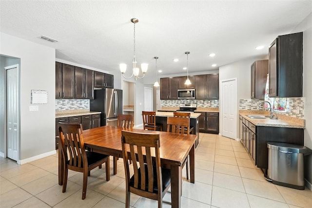 303 Briarbrook Ln, Haines City, FL 33844 - dining space with a chandelier, light tile patterned floors, and recessed lighting
