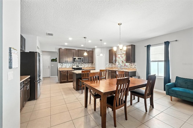 303 Briarbrook Ln, Haines City, FL 33844 - dining space featuring a chandelier, light tile patterned floors, a textured ceiling, and recessed lighting
