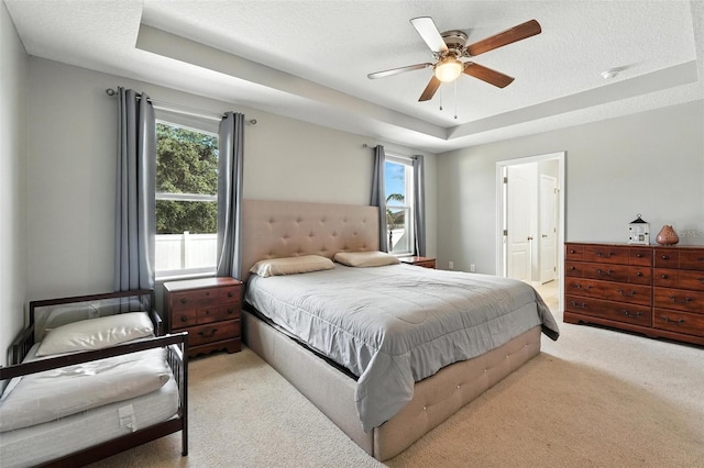 303 Briarbrook Ln, Haines City, FL 33844 - carpeted bedroom featuring multiple windows, a raised ceiling, and ceiling fan
