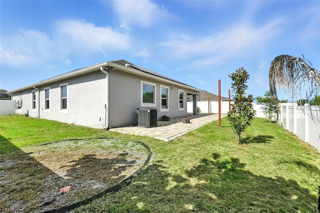 303 Briarbrook Ln, Haines City, FL 33844 - rear view of property featuring stucco siding, a fenced backyard, a patio, and roof mounted solar panels